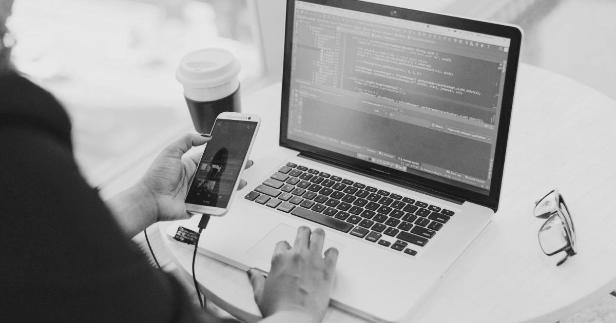 Developer reviewing code on a laptop identifying structural problems in a WordPress site